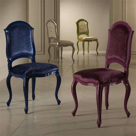 The glamorous charisse dining chair features deluxe layers upholstered in velvet with different colors, supported by upholstered walnut wood legs. Luxury Designer Italian Dining Chair