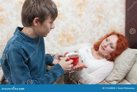Son Giving His Mother Tea Royalty Free Stock Photography