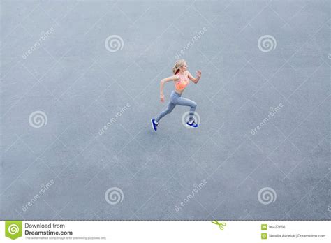 Top View Of Woman Running On City Asphalt Female Runner Training