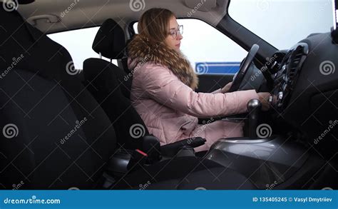 blonde girl gets in the car turns on the ignition shifts gears rides 4k slow mo stock video