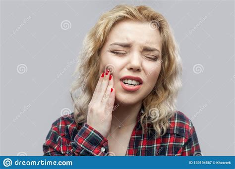 Tooth Ache Portrait Of Beautiful Blonde Young Woman In Casual Red