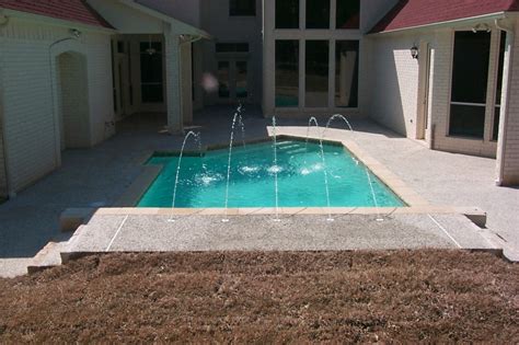 It is constructed outdoor at a given angle of elevation while connected to a building. Deck Jets | King Pools Inc.