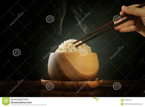 Cooked Organic Basmati Brown Rice With Steam And Chopsticks Stock Photo
