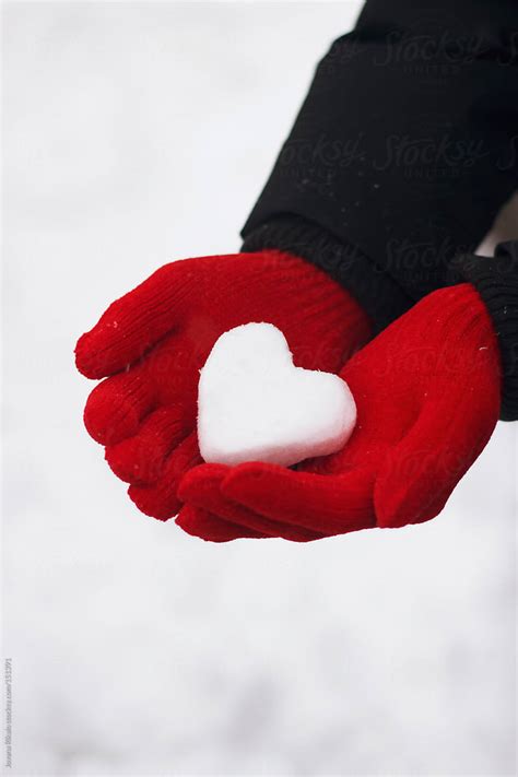 Man Holding Snow Made Heart In His Hands By Stocksy Contributor