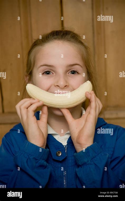 Ten 10 Year Old Girl Happy Looking Smiley Face With A Banana Stock