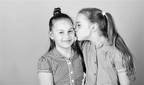 nothing like sisterly love adorable girl kissing her little sister with love stock image