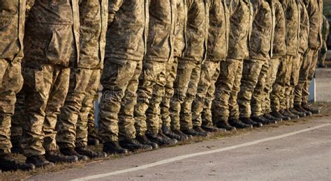 Soldiers Legs In Military Uniform And Boots Standing In Line At Camp