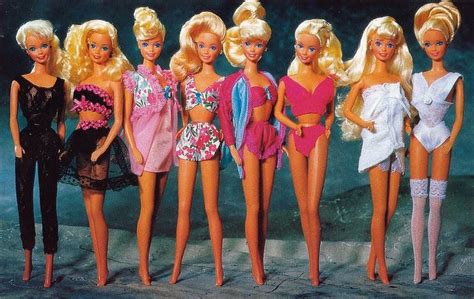 A Group Of Barbie Dolls Standing Next To Each Other