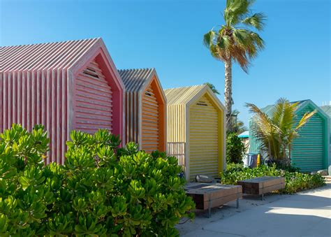 Colorful Beach Huts Near Green Trees Under Blue Sky · Free Stock Photo