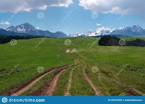 Beautiful Green Mountain Valley With Suv Driving On It Off Road