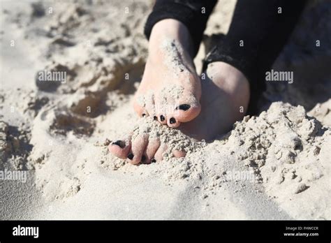 Womans Foot Relax On The Beach Beach Holiday Feet Of A Woman Buried