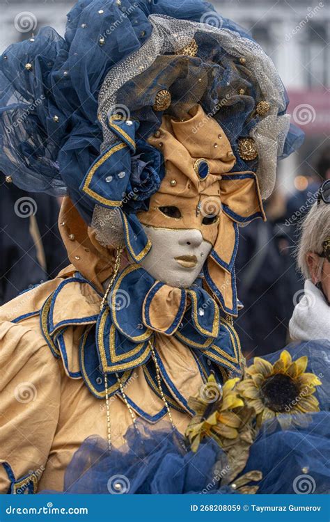 Venice Carnival A Woman In A Yellow And Blue Carnival Costume Of A