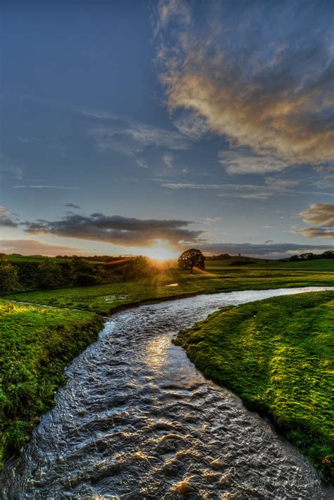 Curved Flowing River Between Grass Open Field Rays Hd Wallpaper
