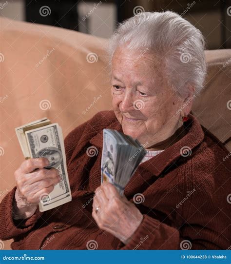 Old Smiling Gray Haired Woman Holding Dollar Cash Money Stock Photo
