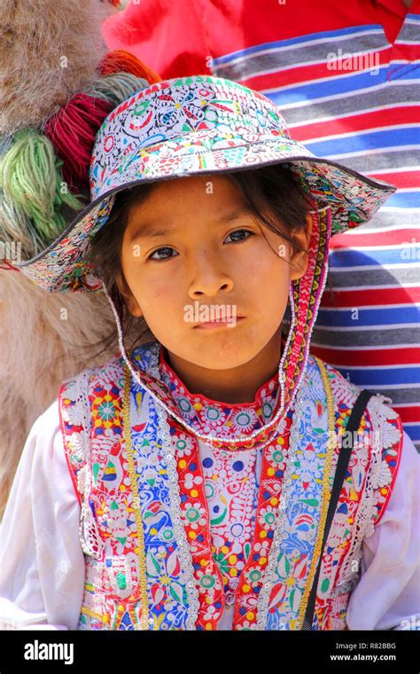 Girl In Traditional Dress Sitting At The Market In Maca Village In