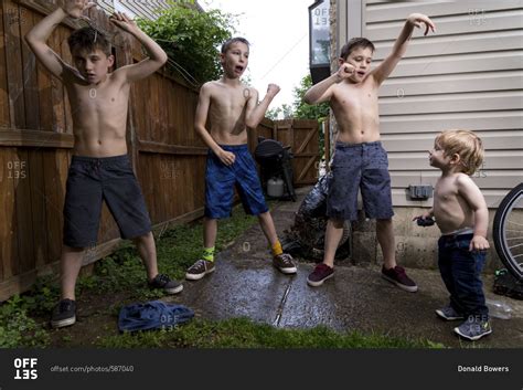 Four Caucasian Boys Playing Outside A Home In Summer Stock Photo Offset