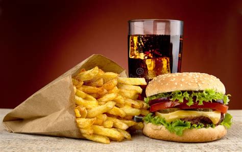 Cheeseburger With Drink Of Cola French Fries On Red Spotligh Stock