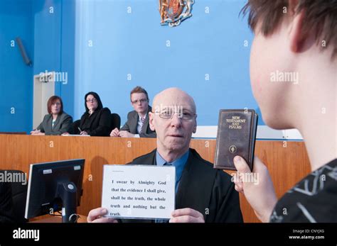 A witness swearing the oath in a magistrates' court Stock Photo - Alamy