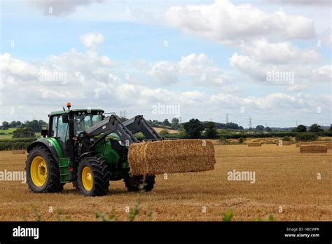 Seasonal Harvester Stacking Square Straw Bales Stock Photo Alamy