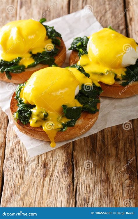 Breakfast Of Poached Eggs With Spinach And Hollandaise Sauce On Bread