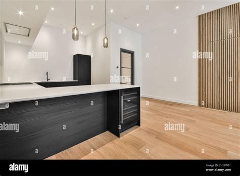 Interior Of Spacious Kitchen With Minimalist Black Furniture And Mini