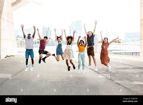 Happy Multiracial People Jumping Together Outdoors Stock Photo Alamy