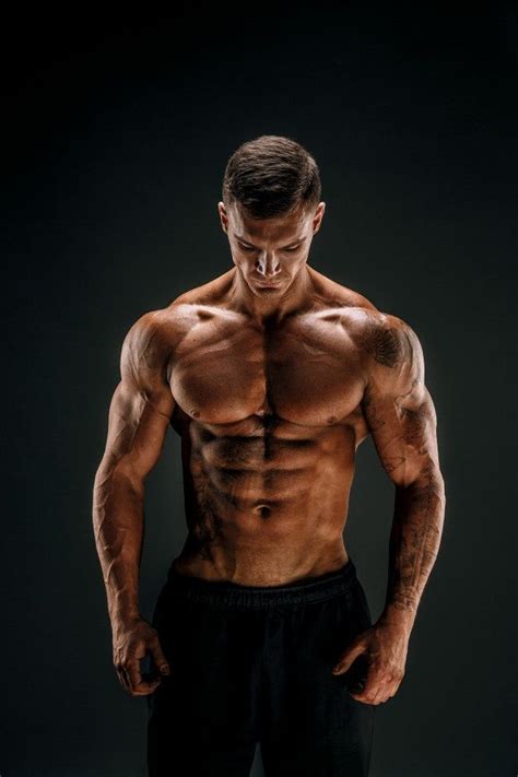 Premium Photo Bodybuilder Posing Fitness Muscled Man On Dark Scene Body Building Men