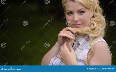Young Lovely Blonde Girl Posing In A Park In Summer Stock Footage