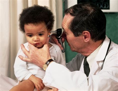 Gp Doctor Uses An Otoscope To Examine Childs Ear Stock Image M825
