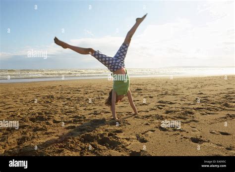 Girl Doing Handstand On Beach Camber Sands Kent Uk Stock Photo Alamy