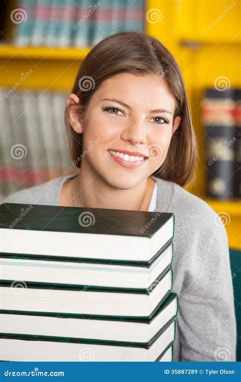 Beautiful Student With Piled Books Smiling In Stock Image Image Of