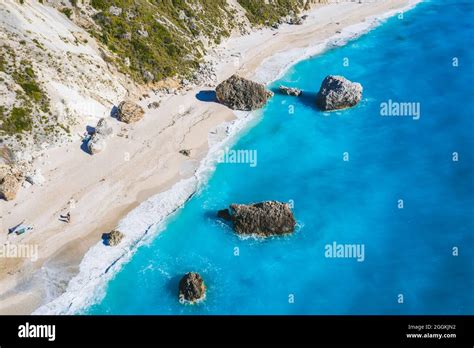 Aerial View Of Kalamitsi Beach With Big Boulders In Turquoise Blue