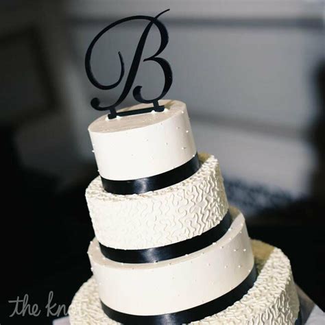 Black and white wedding cake designs look their best with black satin ribbons wrapped around the tiers and fresh white flowers. Four Layer Black & White Cake