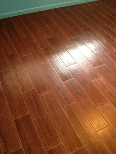 Porcelain tile flooring with border in entry hall; Porcelain Plank Wood Look Tile Installations Tampa, Florida