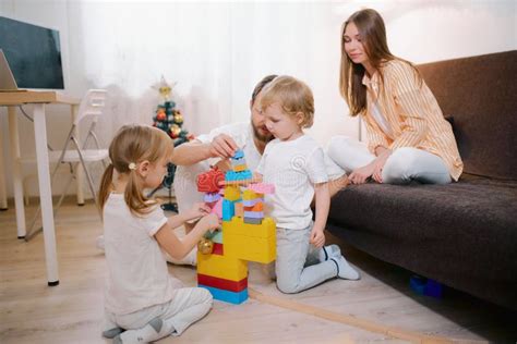 Careful Parents Looking After Children At Home Stock Photo Image Of