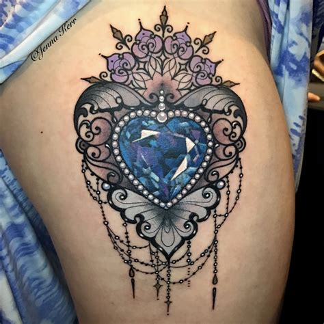 A Woman S Thigh With A Blue Heart Tattoo On It And An Instagram