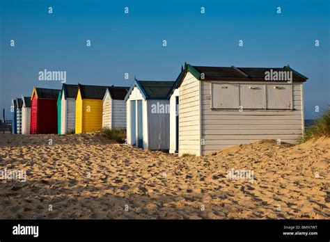 A Row Of Brightly Coloured Beach Huts In Southwold Suffolk Stock Photo