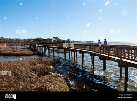 Two Men Walking On The Duck Soundside Boardwalk In The Outer Banks Of