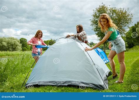 Smiling Friends Setting Up Tent Outdoors Stock Image Image Of Leisure