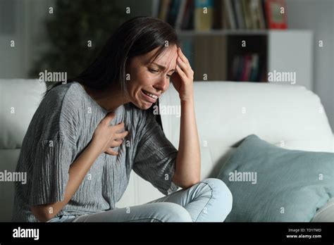 Sad Woman With Broken Heart Complaining Sitting On A Couch In The Living Room At Home In The