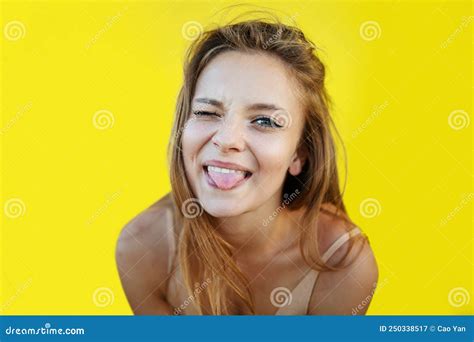 blonde woman making funny face positive girl acts on the camera blinks sticks out her tongue