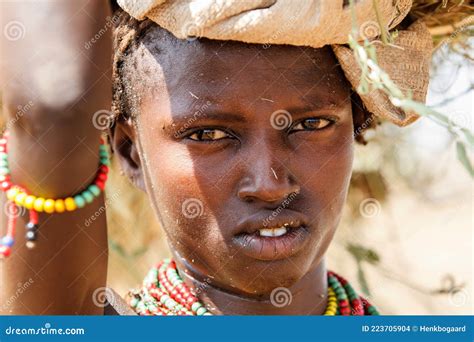 Portrait Of A Young Himba Woman With Her Child Wearing Traditional