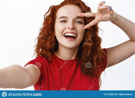 Close Up Of Beautiful Smiling Redhead Woman Showing V Sign And Laughing