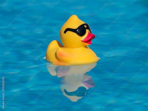 Yellow Rubber Duck With Black Sunglasses Floating On A Beautiful Blue