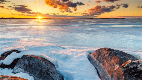 Download Wallpaper 2560x1440 Horizon Sunset Stones Ice Snow Widescreen 169 Hd Background