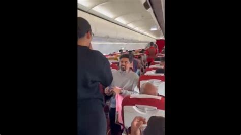love is in the air on air india flight man gets down on his knee proposes to fiancée watch