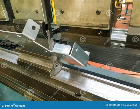 Bending Sheet Metal With A Hydraulic Machine At The Factory Stock Photo