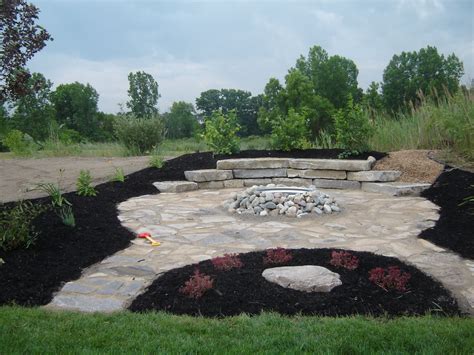 Rock Fire Pit With Sitting Wall And Two Flagstone Entryways Fire Pit