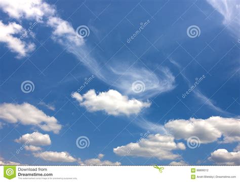 Dramatic Blue Sky With Puffy White Clouds In Bright Clear Sunny Stock