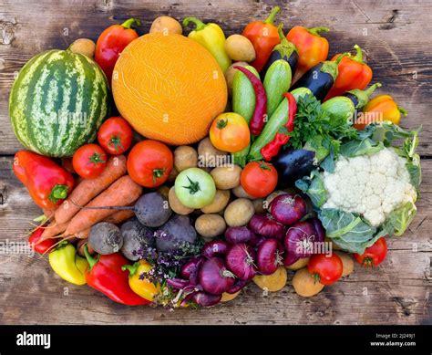A Bunch Of Colorful Vegetables On A Wooden Surface Stock Photo Alamy